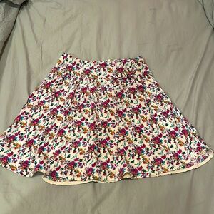Short floral skirt with white background.